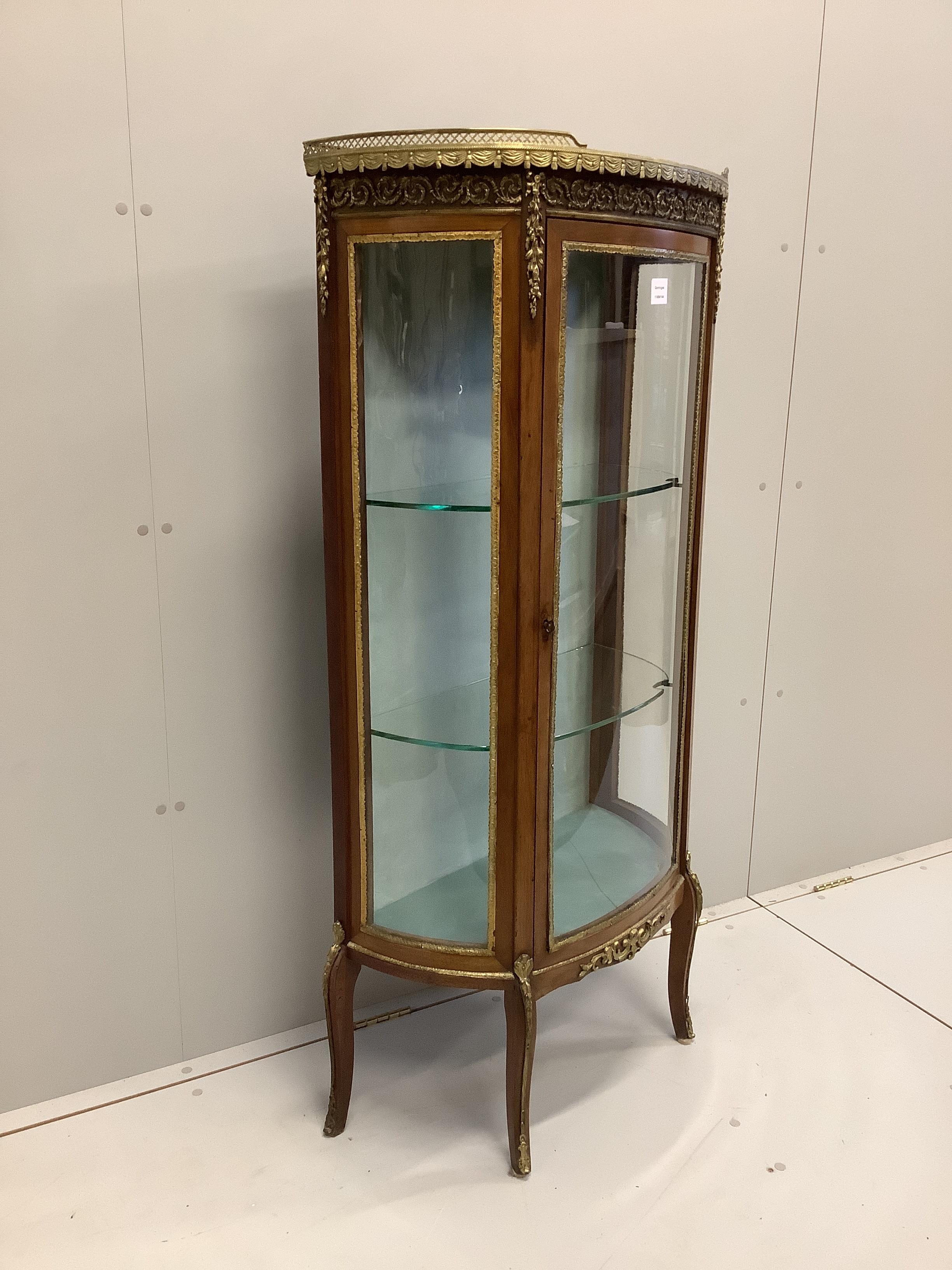 A French gilt metal mounted marble topped bow front vitrine, width 66cm, depth 32cm, height 140cm